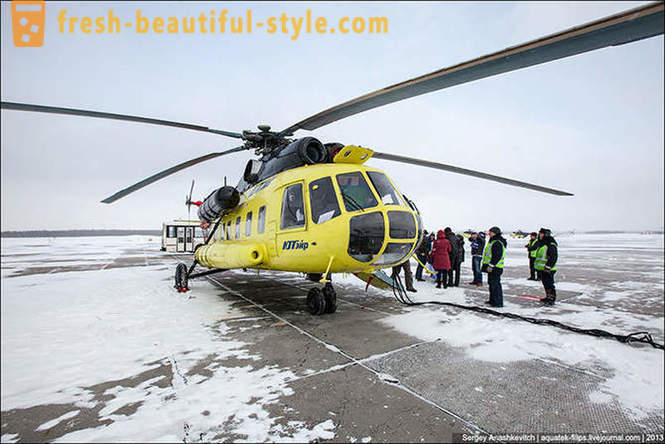 Flying by helicopter Mi-8 on snow Surgut