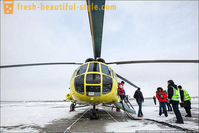 Flying by helicopter Mi-8 on snow Surgut